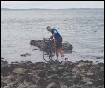 Ken ceremoniously dips his bike in the Pacific Ocean at the start of his coast-to-coast journey.