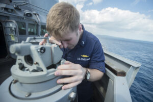 Coast Guard Lt. j.g. Jacob Christopher Hauser, from North Salem, N.Y., uses an alidade to take range and bearing from the port bridge wing of the Arleigh Burke-class guided missile destroyer USS Stethem (DDG 63). Stethem is on patrol with the George Washington Carrier Strike Group supporting security and stability in the Indo-Asia-Pacific region. (U.S. Navy photo by Mass Communication Specialist Seaman Alonzo M. Archer/Released)