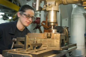 EAST CHINA SEA (Feb. 10, 2015) Machinery Repairman Fireman Cynthia Gramuglia, from New Milford, N.J. mills a channel for a valve coupling in the machine shop aboard the forward-deployed amphibious assault ship USS Bonhomme Richard (LHD 6). Bonhomme Richard is currently deployed in the U.S. 7th Fleet Area of Operations. (U.S Navy photo by Mass Communication Specialist 3rd Class Cameron McCulloch/ Released)