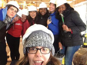 Pictured on this page and the next one are local college student volunteers hard at work finishing a Veteran's home in Yonkers in late January.