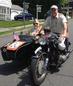 This year’s parade “won’t be the same” without Gabby Rosenfeld, who was awarded a French Legion of Honor medal. Here, Gabby in the motorcade alongside his son Eric.