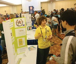 Zachary Eichenberger explains the team’s app to interested convention goers. Leslie Shih Photo