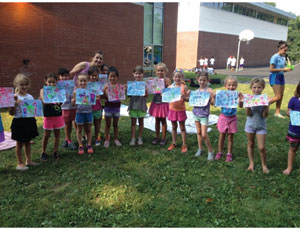 Proud campers showing off their artwork