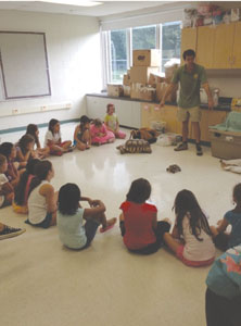 Campers enjoy seeing a turtle during a visit from a nature specialist