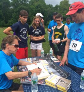 Bill Rodgers signs copies of his book, Marathon Man
