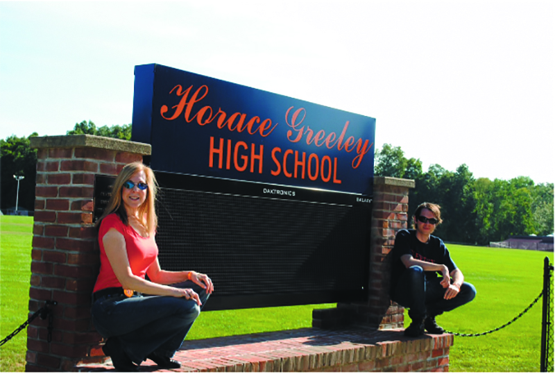 Back at their mutual alma mater, Tracy and Luke show their HGHS spirit.