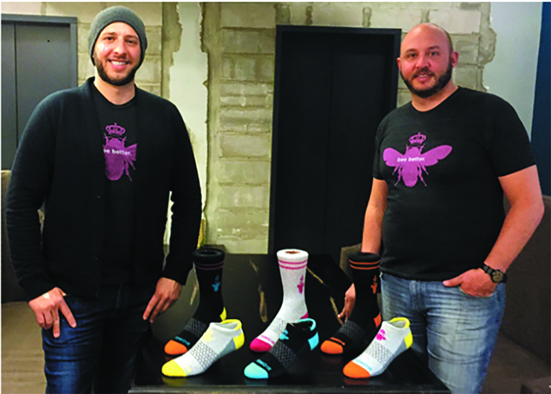 David (left) and Andrew Heath with their colorful Bombas socks.