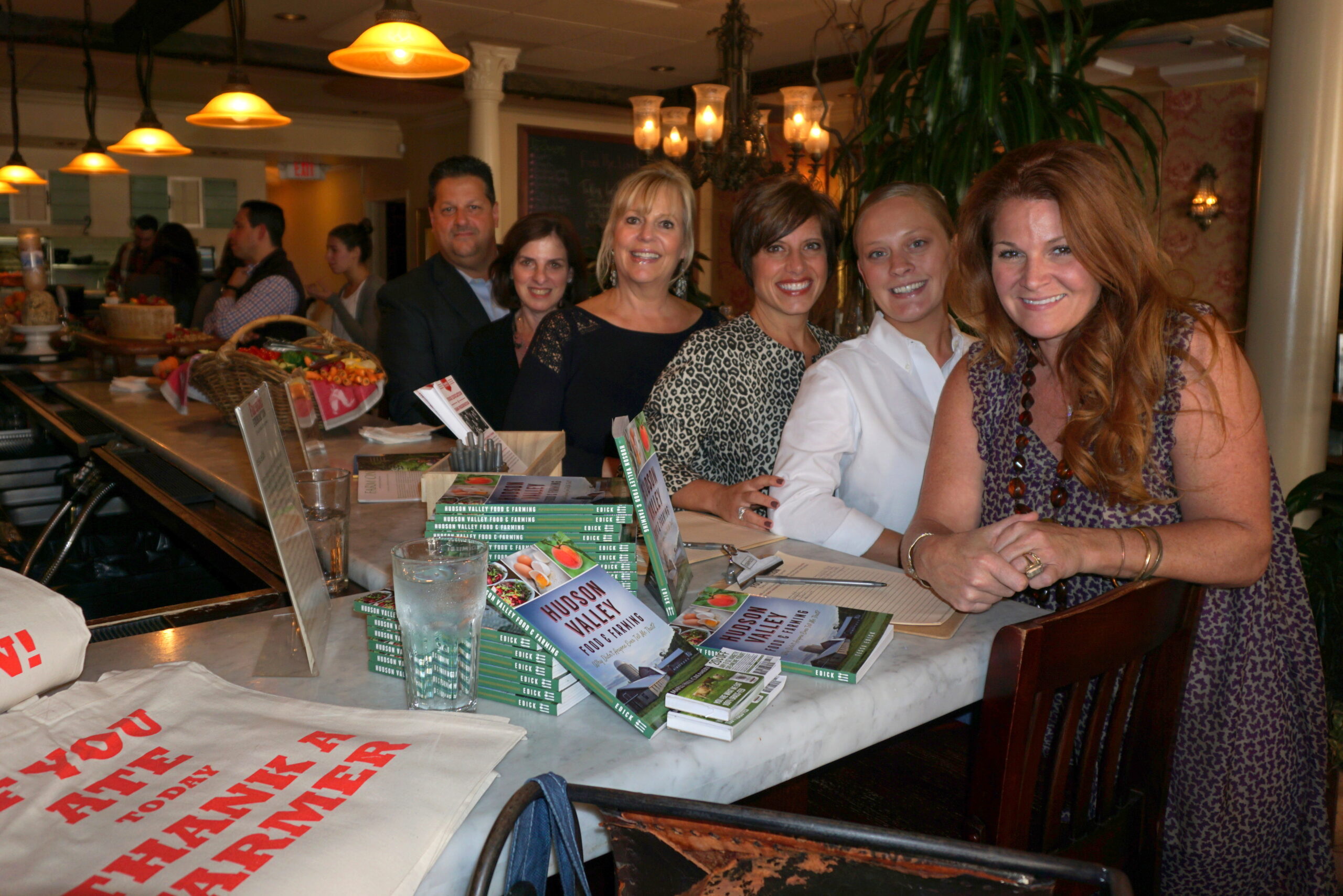 Back to front: Barry Graziano, Chappaqua & Armonk Manager, Houlihan Lawrence; Roselyn Harburger, Katonah Manager, Houlihan Lawrence; Leslie Lampert, Owner, Cafe of Love; Amanda Gomolka, Manager, Cafe of Love; Jackie Graziano; Westchester Ambassador, FarmOn! Foundation; and Tessa Edick, Executive Director, Founder, FarmOn! Foundation