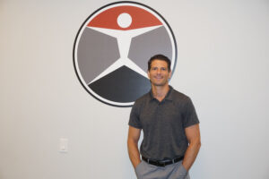robert fay in front of logo