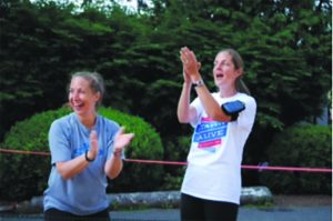 Stayin’ Alive Inc. Co-Founders Michele Berliner (left) and Christy Saltstein (right) cheer on runners during the 2nd Stayin’ Alive 5K Fun Run held in May 2015.