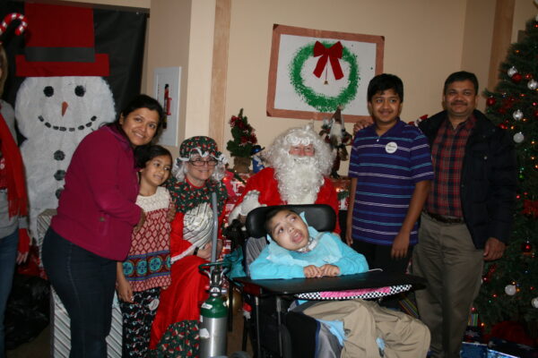 Jay Lokhande, who lives at the Sunshine Children's Home, along with his family celebrating Christmas with Santa and Mrs. Claus. 
