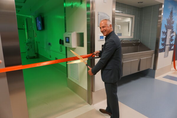David Miller, MD, cutting the ribbon outside the operating room named for him.