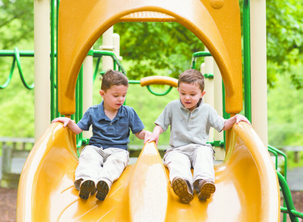 The author’s twin boys’ tandem sliding at the smaller playground at Gedney Park.