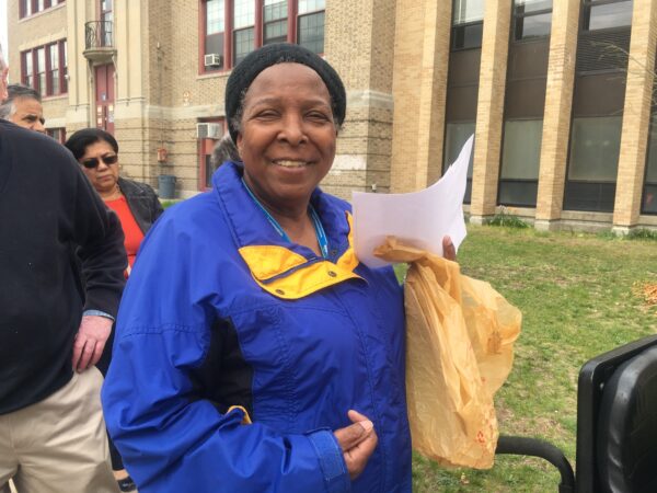 A Clinton supporter waits outside the high school before entering the rally. "“What a beautiful woman,” she said about Hillary Clinton. “I can’t wait for her to be president.”