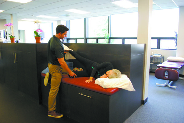 Physical therapist John Connolly works with client Gwen Grotta at Armonk Physical erapy & Sports Training