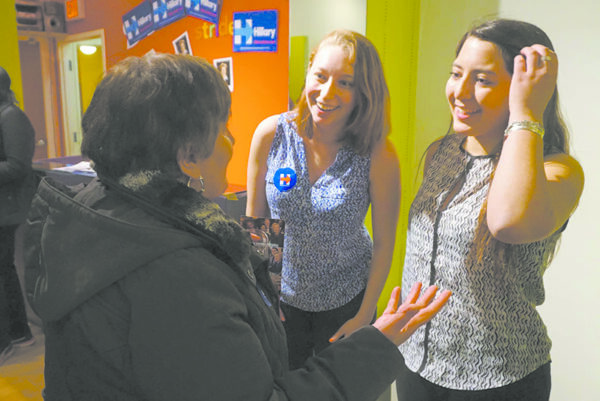 Westchester field organizers Hannah Fine and Izzy Bugatti greet a volunteer at the White Plains HRC campaign headquarters grand opening.