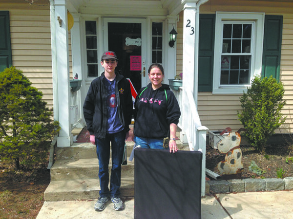 Boy Scout Jack Kiernan delivers 100 dog beds to local animal shelters.