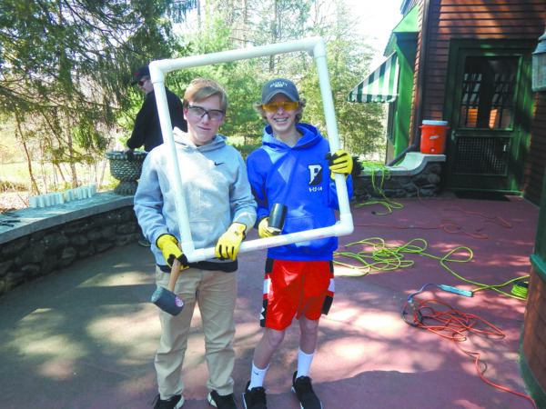 Boy Scouts Kyle and Ryan construct PVC frames.