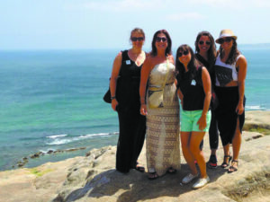 Miriam (second from left) on a cliff in Morocco with new friends met on a guided tour.