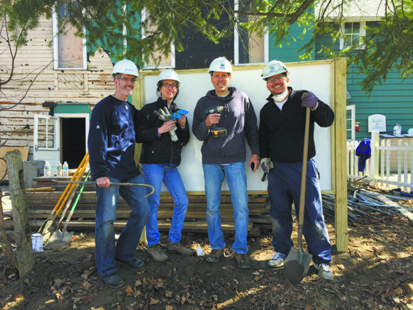 Smiles all around after heavy-duty digging and sign-building. (L-R): Chappaqua resi- dents Michael and Eileen Gallagher, Greg Simon, and Warren Gottlieb.