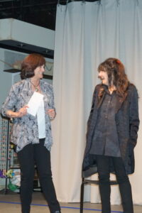 Board member Nori Fromm on stage with Reichl at the Friends of the North Castle Public Library May 4 event.