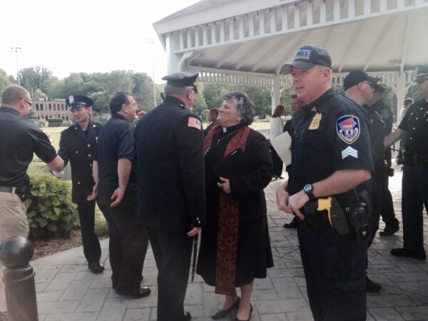 Rev. Martha Jacobs greeting New Castle police officers.