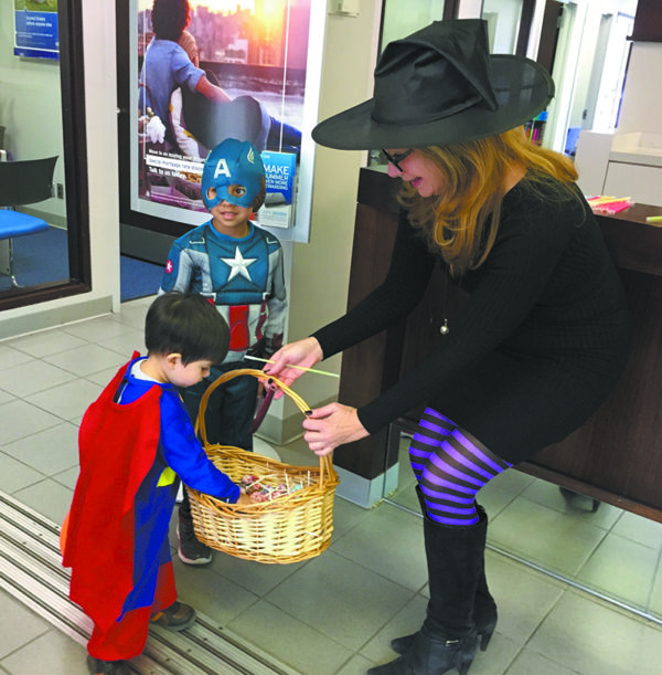 A family favorite each year. Here, Chris O'Neill at Citibank engages two trick or treaters!