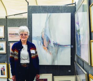 Rosalind Oesterle, an Armonk Outdoor Art Show participant since moving to Armonk the 1970s, with some of her paintings on display, on September 24, 2016. Photo © 2016 Marianne A. Campolongo.