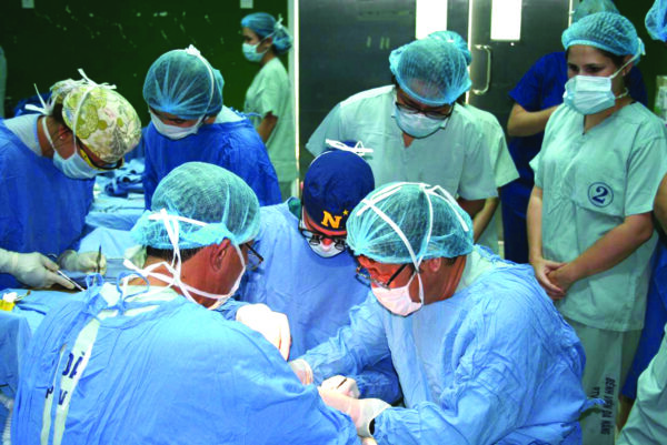 Dr. Elan Singer on a Humanitarian Medical Mission in Vietnam Pictured in the “N” Cap