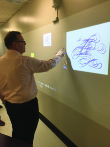 Dr. Andrew Taylor demonstrates the new technology.